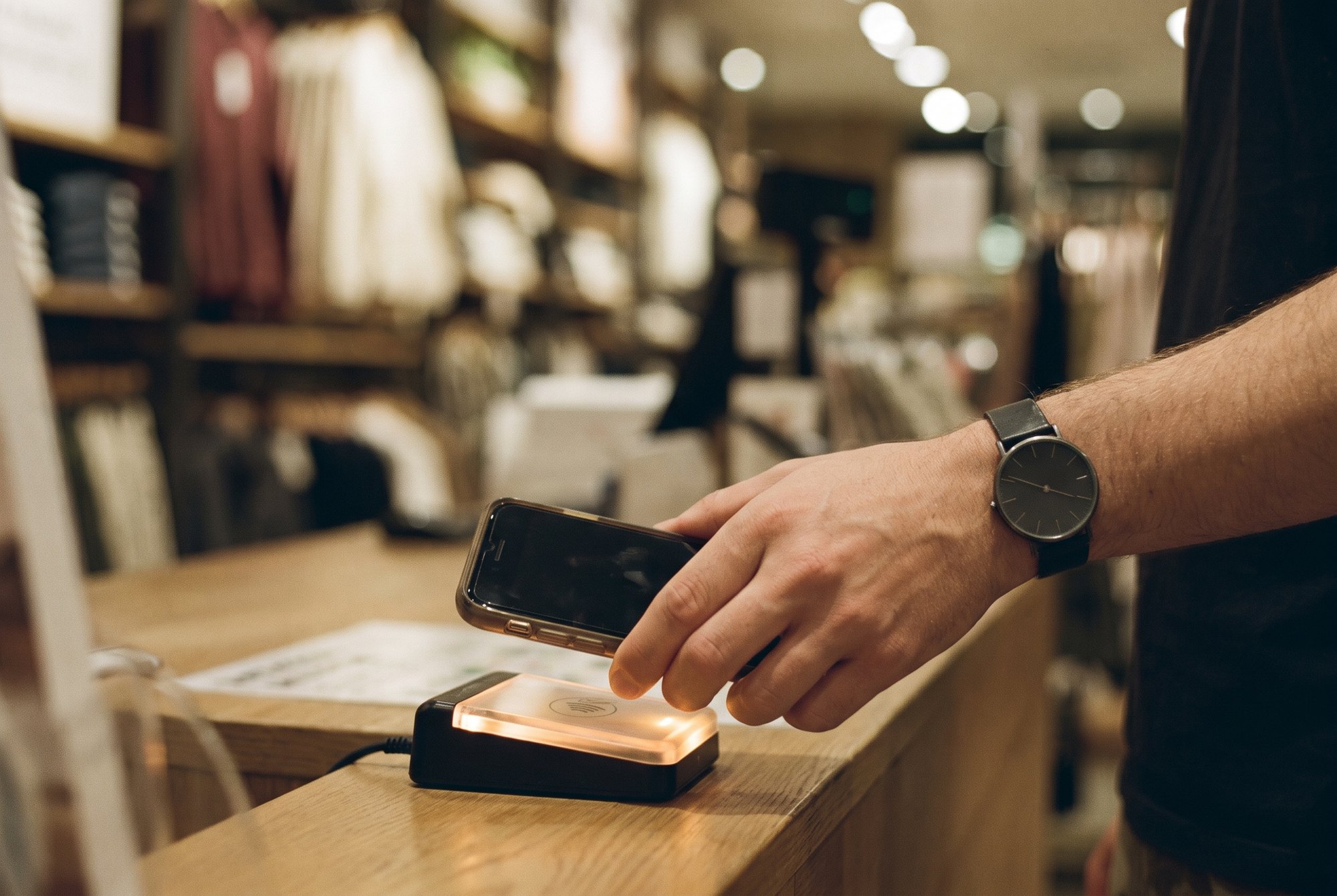 A contactless payment at a counter, the small transaction that proves the rent is working.